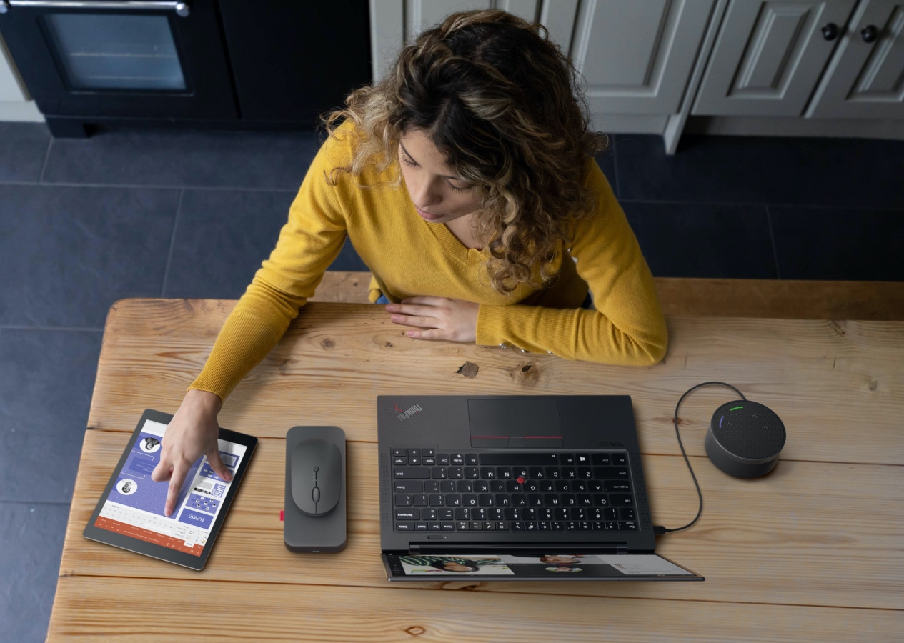 A girl having an online meeting call and taking note with her tablet