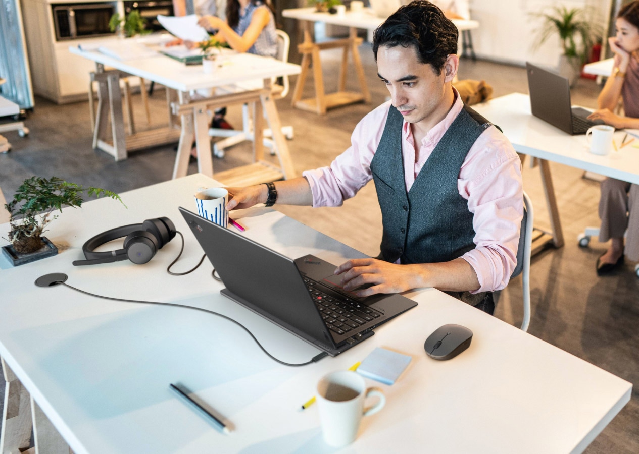 A man working on his office using Lenovo ThinkPadX1 Laptop